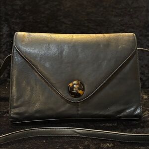 Chic Black Leather Clutch with Tortoiseshell Accent